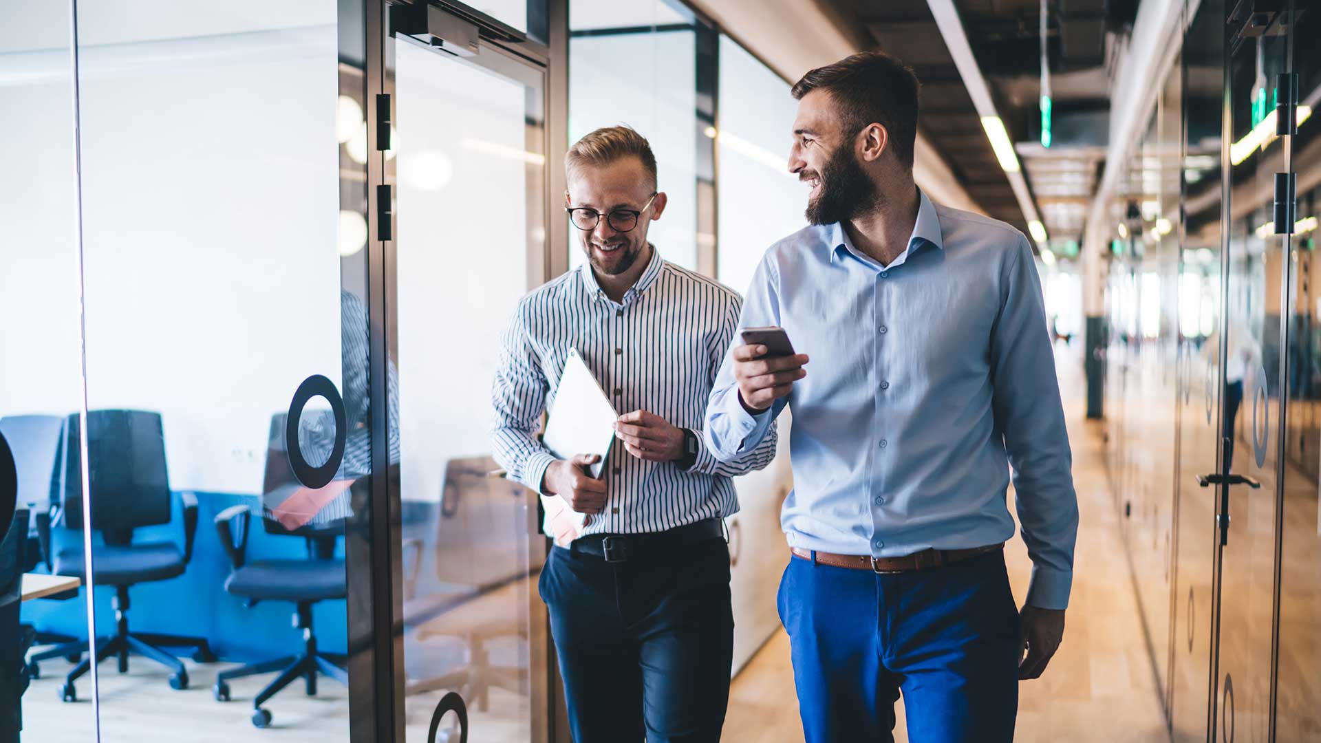 smiling men walking in corridor