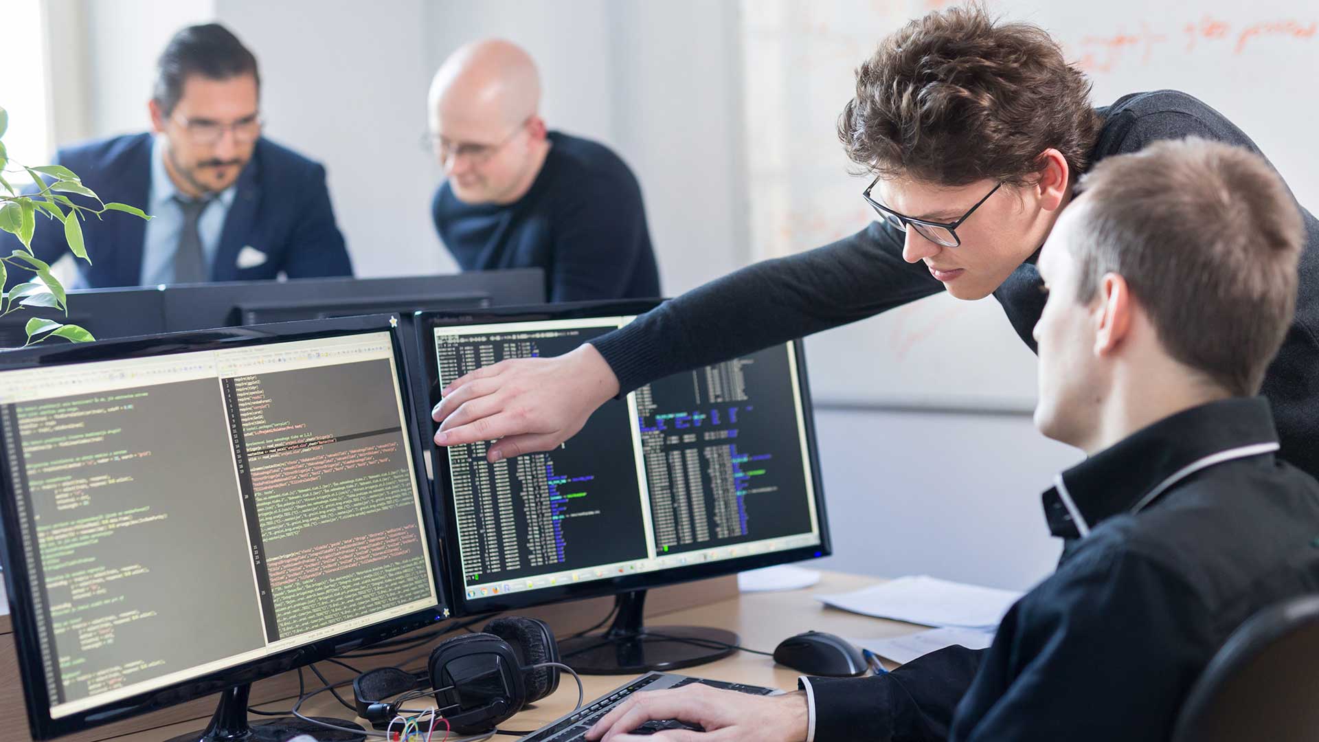 software developers by computer monitors