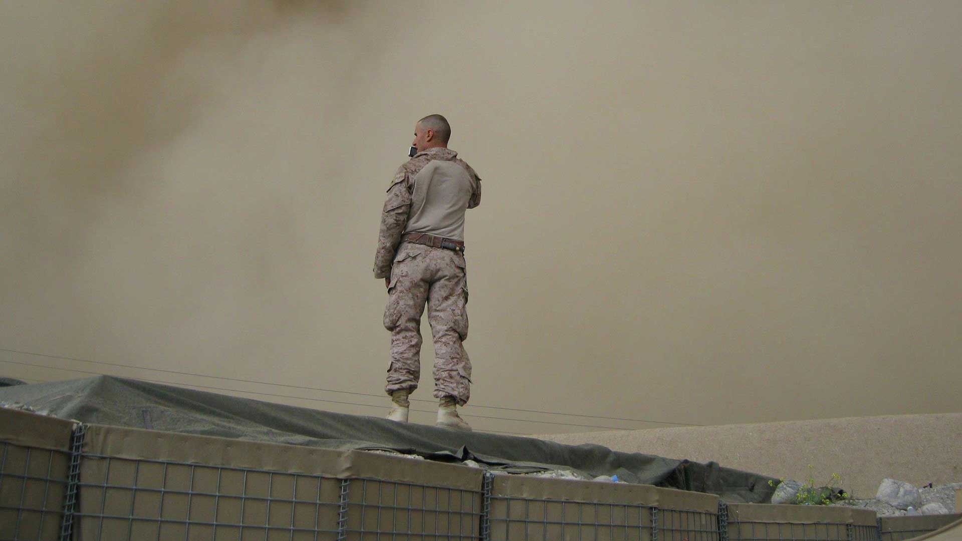 soldier in a sandstorm communicating